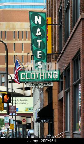 The iconic green and white neon sign for Nate’s Clothing store in downtown Minneapolis, Minnesota at 27 North 4th Street.  Nate’s was a family owned b Stock Photo