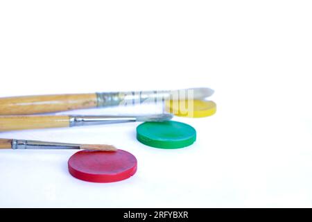 used brushes and watercolors on white background Stock Photo