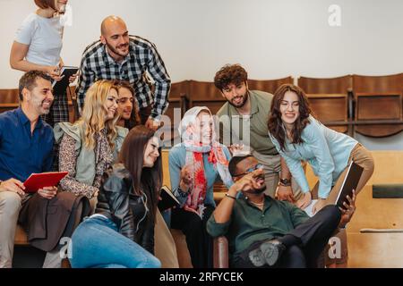Young and enthusiastic group of businesspeople taking a selfie all together at the office Stock Photo