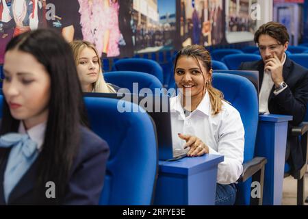 Students working on their laptops while attending class Stock Photo
