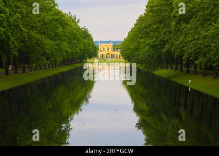 Kassel, Hesse, Germany - 30 June 2023: View in Karlsaue Park over the water canal with its tree-lined avenues to the Orangerie. Stock Photo