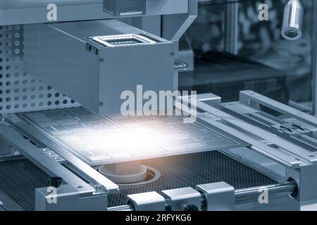 Close up of examining of test sample of microchip transistor under the microscope in laboratory. Equipment for testing microchips. Automation of produ Stock Photo