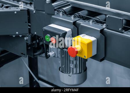 Automatic packaging belted conveyor system in a pharmaceutical plant. Selective focus. Industrial machine for packing plastic boxes in food Stock Photo