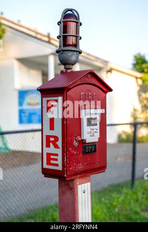 Ridgewood, NJ - USA – Aug 2, 2023 Vertical view of a red and white callbox,  also know as a fire alarm box or fire alarm pull box. The device is used Stock Photo