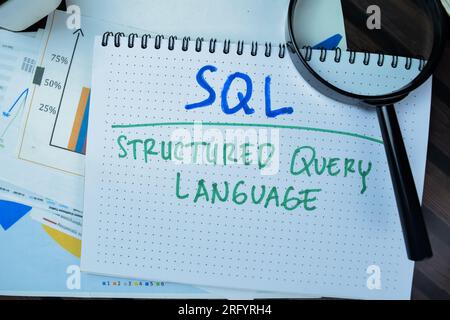 Concept of SQL - Structured Query Language write on book isolated on Wooden Table. Stock Photo