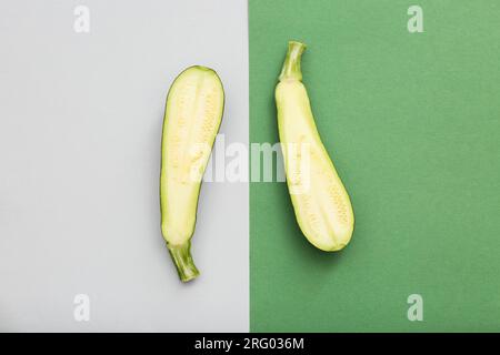 Halves of fresh green zucchini on colorful background Stock Photo