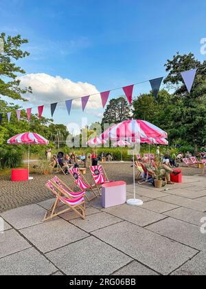 BERLIN, GERMANY - JULY 22, 2023: Sun loungers and umbrellas with the logo of the KULTUR SOMMER FESTIVAL in the Britzer Garten. Stock Photo