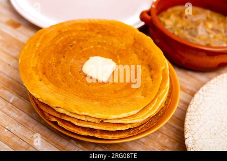 Pancakes with butter and mochanka of meat and mushrooms Stock Photo