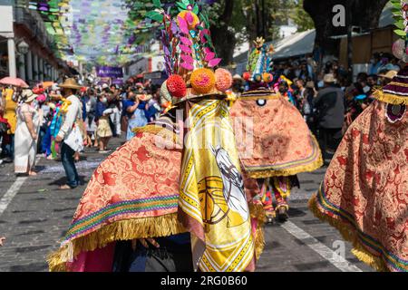 Mexican costumed dancers perform the La Danza de los Moros or Dance of the Moors at the start of the Palm Sunday Handcraft Market or Tianguis de Domingo de Ramos April 9, 2022 in Uruapan, Michoacan, Mexico. The week long handicraft market is considered the largest in the Americas. Stock Photo