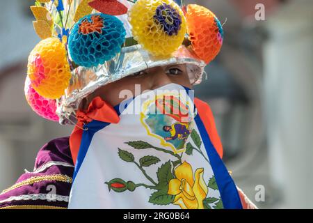 Mexican costumed dancers perform the La Danza de los Moros or Dance of the Moorsartisans at the start of the Palm Sunday Handcraft Market or Tianguis de Domingo de Ramos April 9, 2022 in Uruapan, Michoacan, Mexico. The week long handicraft market is considered the largest in the Americas. Stock Photo