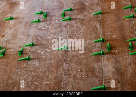 Plastic tile leveling system clips and wedges leveling install tools tile leveling system spacer. Stock Photo