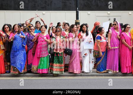 London, UK. 6th August, 2023. Around 500 British-Indian women wore unique colourful handmade sarees as they arrived in Westminster for a 'Walkathon' event beginning at Trafalgar Square and ending at the Mathatma Gandhi sculpture in Parliament Square.  The women representing different Indian states gathered on the eve of National Handloom Day, paying tribute to the skilled weavers who may take weeks finishing a single saree. Credit: Eleventh Hour Photography/Alamy Live News Stock Photo