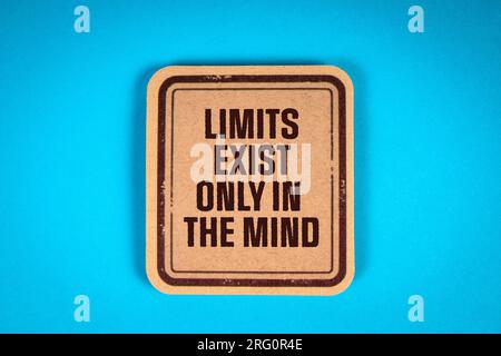 LIMITS EXIST ONLY IN THE MIND. Cardboard sticker with text on a blue background. Stock Photo