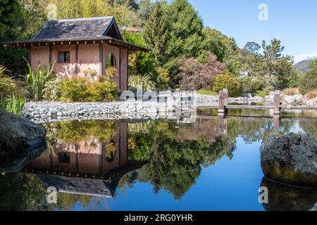 Blue sky with pond and tea house at Miyazu Japanese Garden in Nelson, South Island, New Zealand Stock Photo