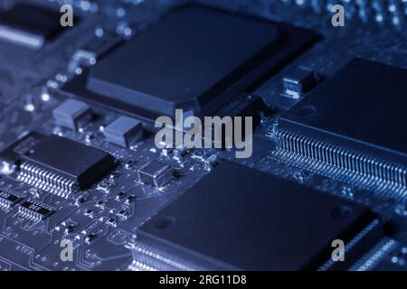 Closeup of Printed Circuit Board with processor, integrated circuits and many other surface mounted passive electrical components. Stock Photo