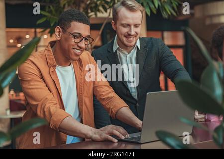 Two managers working on new project and use laptop in coworking office Stock Photo