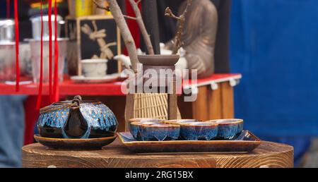 Tea pot and bowls on display in a stall selling a variety of ceramics in the market place in Prague downtown Stock Photo