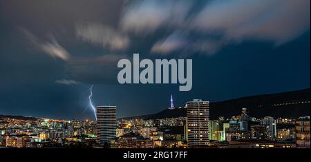 Dramatic sky with lightnings in stormy night over Tbilisi's downtown Stock Photo