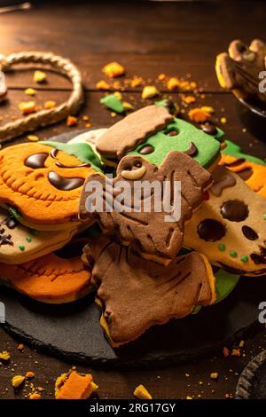 Closeup of bunch of delicious homemade biscuits placed on wooden table in Halloween style Stock Photo