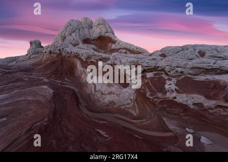 Picturesque scenery of rough rocky mountains under cloudy purple and blue sky at sundown in evening Stock Photo
