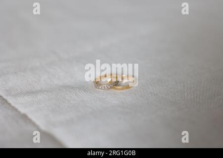 Detail of golden wedding rings, an accessory that symbolizes the union of a couple Stock Photo
