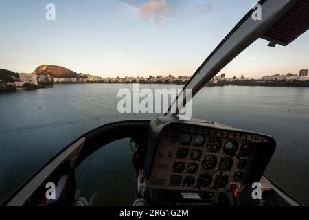 Aerial view from helicopter cockpit flying over city lagoon Stock Photo