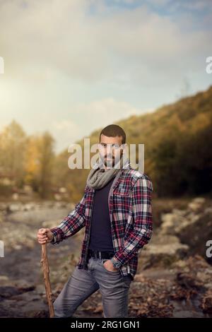 Handsome middle aged man posing on the river Stock Photo