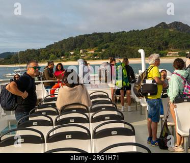 Passengers on board Mar de Ons ferry boat arriving,  Isla del Faro, Cies Islands, Galicia,Spain Stock Photo