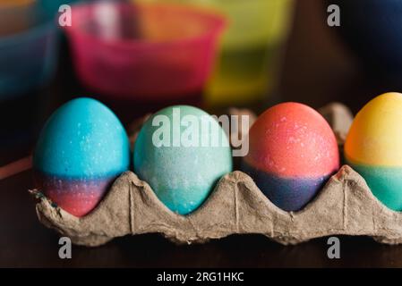 Close up of dyed Easter eggs in bright colors drying  in a carton. Stock Photo