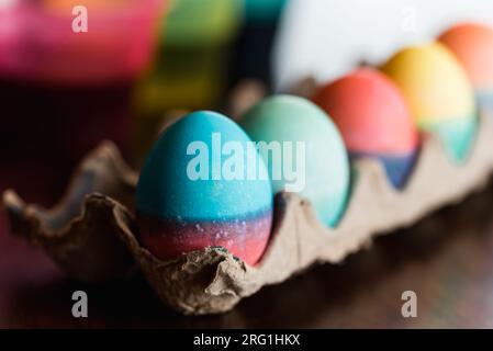 Close up of dyed Easter eggs in bright colors drying in a carton. Stock Photo