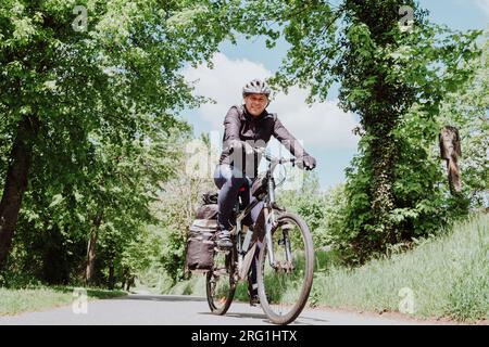 A cyclist riding his bike in a cycle line in Germany Stock Photo