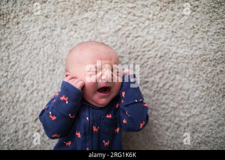 top view of Newborn baby crying on the floor Stock Photo