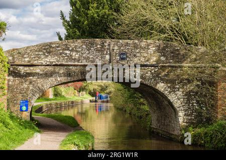 View through old bridge 154 to Narrowboat sailing on Monmouthshire and Brecon Canal. Pencelli, Brecon, Powys, Wales, UK, Britain Stock Photo