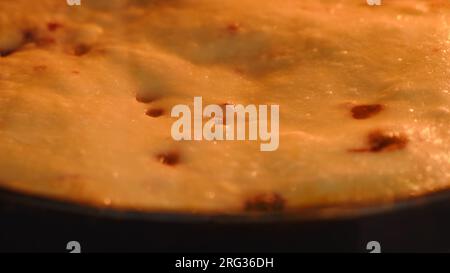 Berry pie made of dough. The process of making sweet pastries in the oven Stock Photo