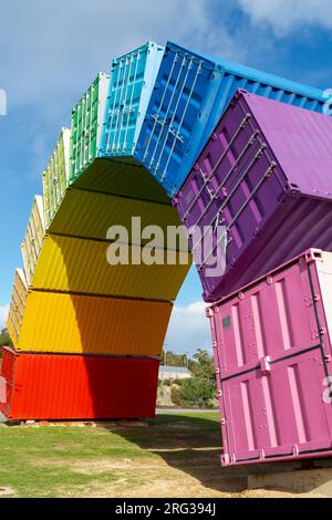 Containbow - a rainbow arch shipping container sculpture installation by Marcus Canning. Stock Photo