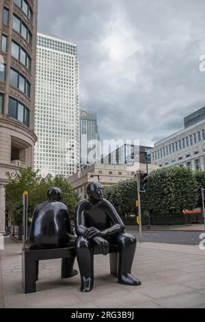 Giles Penny’s Two Men on a Bench is a large bronze work which has a contemplative air at Cabot Square Canary wharf Stock Photo