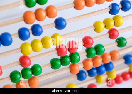 Close up colorful school abacus bead background for kids. Education school mathematics background. Kids learning count, children math class concept. Stock Photo