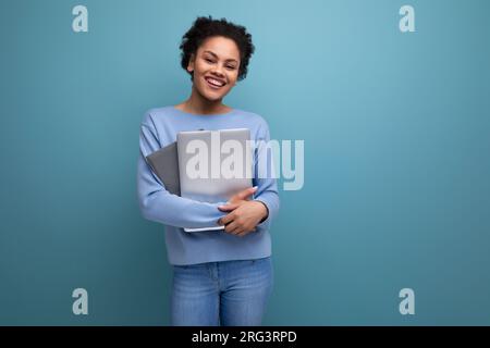 confident young afro hair brunette woman with laptop in office Stock Photo