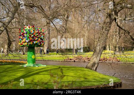 Landscape of field of flower statue by canal at Keukenhof gardens in Lisse Holland The Netherlands Stock Photo