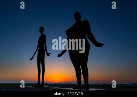 Two ladies waiting for the high tide Stock Photo