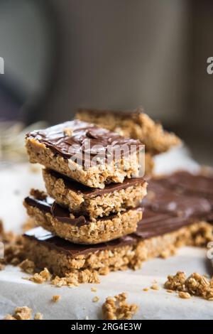 High energy oatmeal bars or squares, made with oatmeal, peanut butter, honey, coconut oil, and cashews, topped with chocolate. Stock Photo