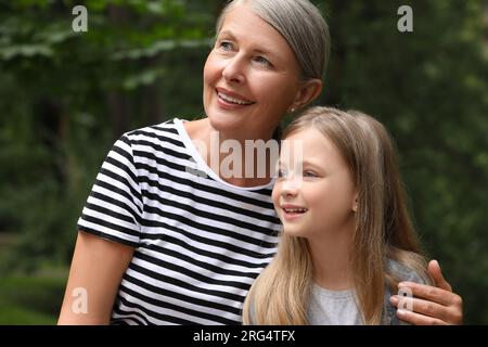 Happy grandmother with her granddaughter spending time together outdoors Stock Photo
