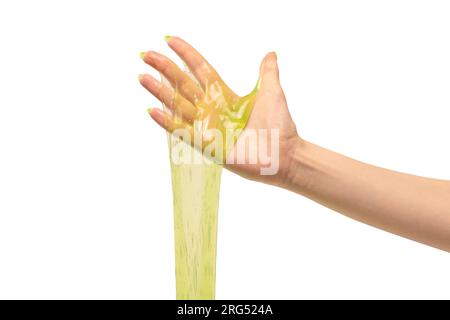 Green slime toy in woman hand with green nails isolated on a white background. Stock Photo