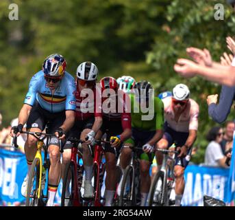 Wout van Aert leading pack of riders UCI Mens Road Race Scotland 2023 with eventual winner Mathieu van der Poel lurking at the back in Kelvingrove. Stock Photo