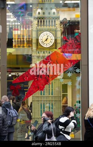 People walk past a model of the Elizabeth Tower, which houses Big Ben, displayed in a shop window in central London, on New Year’s Day. Stock Photo