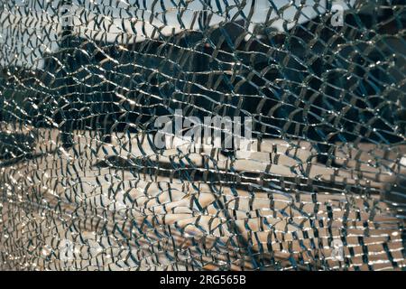 Abstract shot blurred summery city square through cracked broken glass. Conceptual avant-garde background for a website or landing page. Copyspace Stock Photo