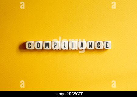 Compliance - word concept on building blocks, text Stock Photo