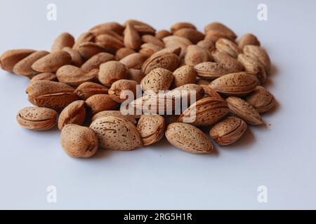 Selective focus of almonds in the shell. İsolated on white background. Stock Photo