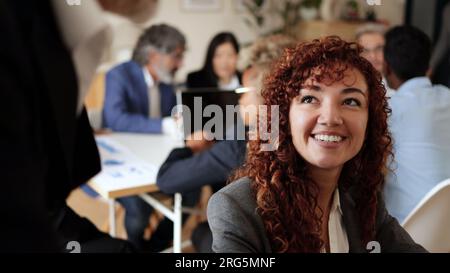 Business woman working inside bank office - Entrepreneur finance team concept - Focus on latin girl face Stock Photo