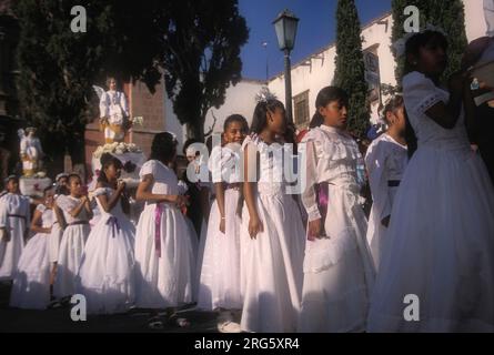 Young girls in white dresses during religious procession, Semana Santa, San Miguel de Allende, Mexico Stock Photo
